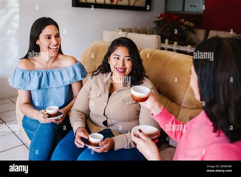 Latin Girls Having Fun At Home Laughing And Drinking Coffee In Mexico