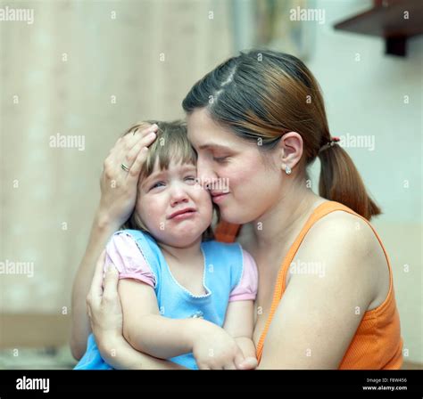 Woman Soothes Crying Daughter Focus On Woman Stock Photo Alamy