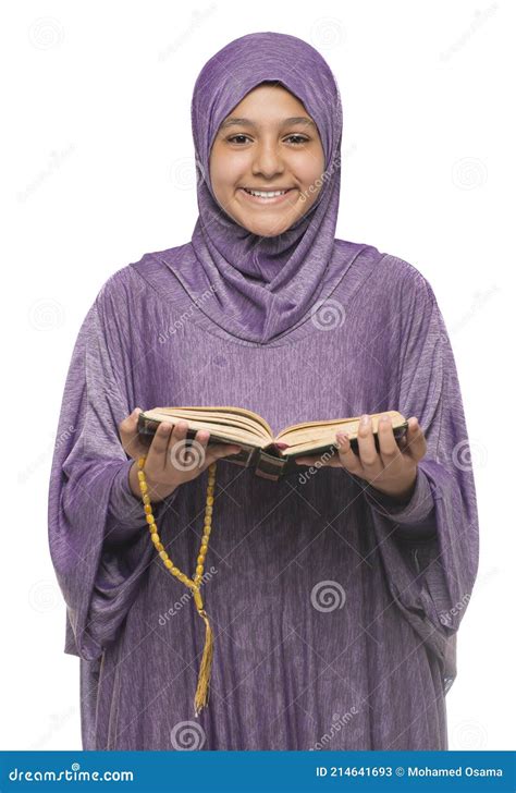 Beautiful Muslim Girl In Islamic Fashion Dress Holding Holy Book Of