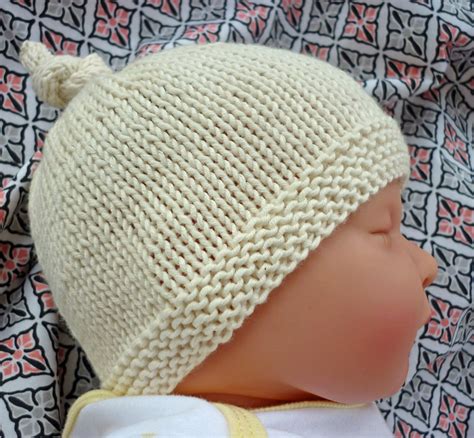 Looking for free hats knit patterns? lovefibres: Tegan - Baby Hat with Top Knot Pattern