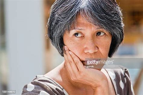 Mature Woman Asian Sad Photos And Premium High Res Pictures Getty Images