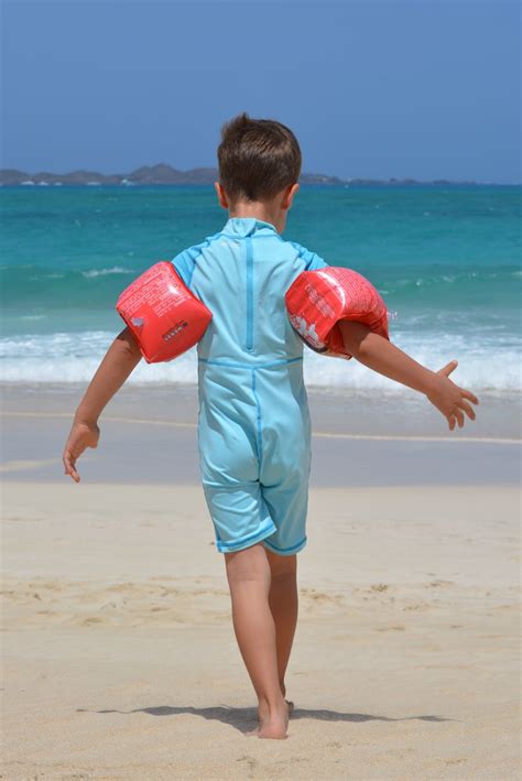 Boy On Blue Onesie On Beach During Day · Free Stock Photo