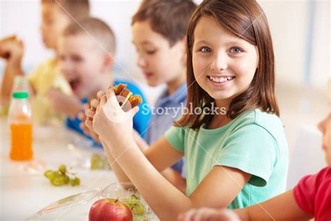 Group Of Classmates Having Lunch During Break With Focus On Smiling