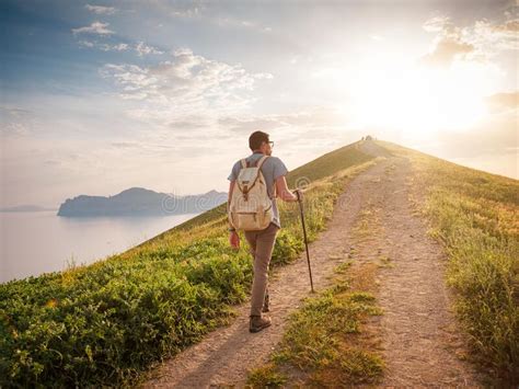 Young Man Travels Alone On The Backdrop Of The Mountains Stock Image