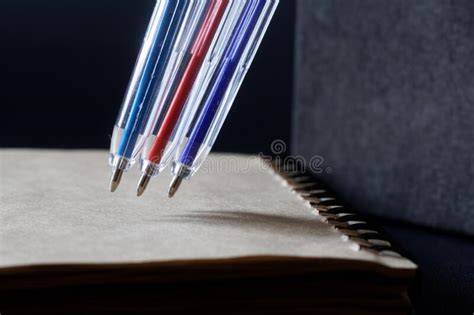 Colorful Ballpoint Pens Next To An Eco Friendly Recycled Notebook