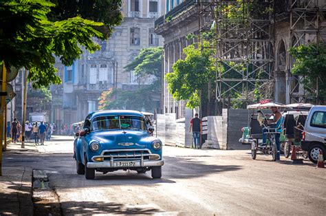 Old American Classic Car Taxi And Bikes And Bicitaxi In Cuba Stock