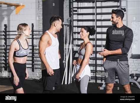 Positive Interracial Friends In Sportswear Talking In Gym Stock Photo Alamy