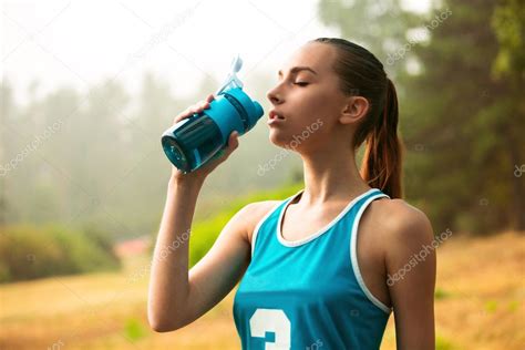 A Sport Girl Drinks Water — Stock Photo © Profstock 80728386