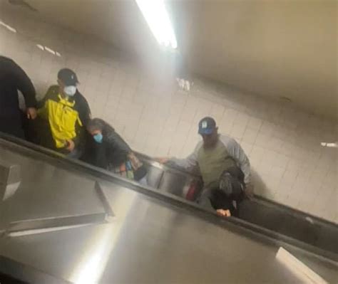 Shocking Moment Two Brawling Men Plummet Down Escalator In Grand