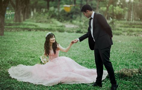 Download Romantic Asian Couple Prenup On Grass Wallpaper
