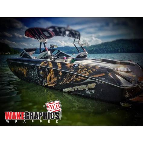 The Wake Graphics Boat Is Parked In The Water