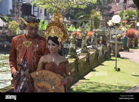 Balinese Couple In Traditional Dress Take Wedding Photos Inside