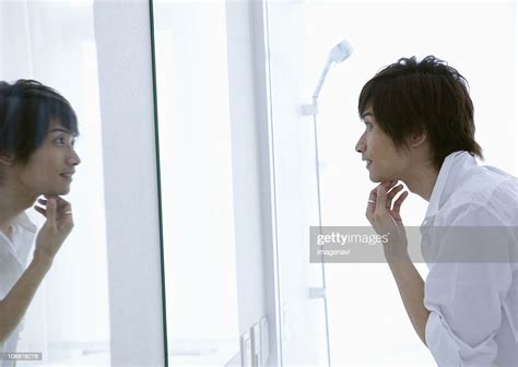 Young Man Looking In Mirror High Res Stock Photo Getty Images