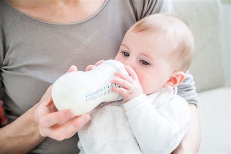 Baby Girl Drinking Milk From A Bottle Stock Image C