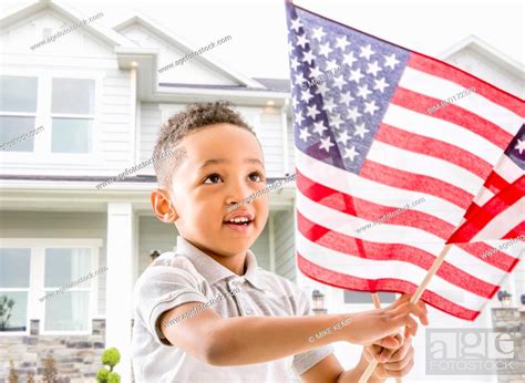 Mixed Race Boy Waving American Flag Stock Photo Picture And Royalty