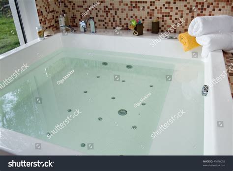 If filling the tub with water is beneficial why all the way? Spacious Bathtub Filled Water Stock Photo 41676055 ...