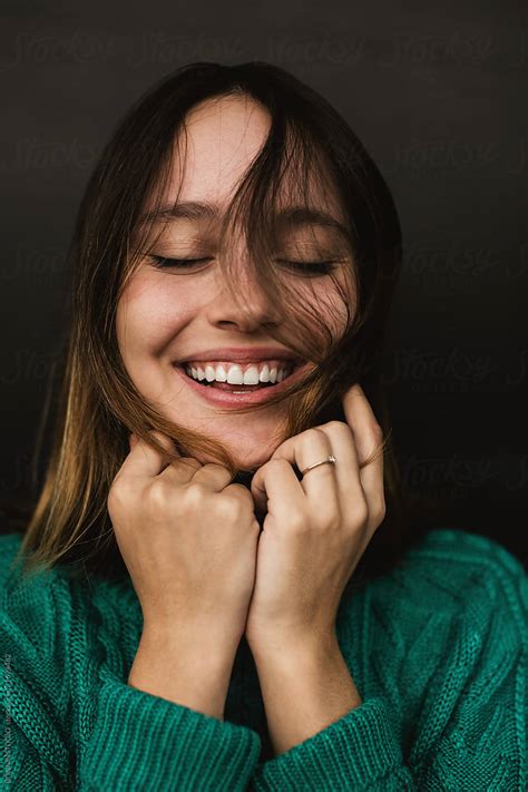 Portrait Of A Happy Girl Wearing Green Knitted Sweater By Stocksy