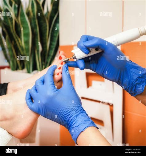 Feet being treated by professional pedicure specialist, chiropodist