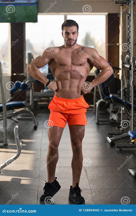 Muscular Man Flexing Muscles In Gym Stock Photo Image Of Bench