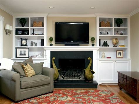 How to hide your tv on a swivel mounted arm. Simple white built in bookshelves with lower cabinets for ...
