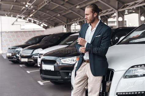 Confident Young Adult Businessman Standing Near Car On Parking Stock