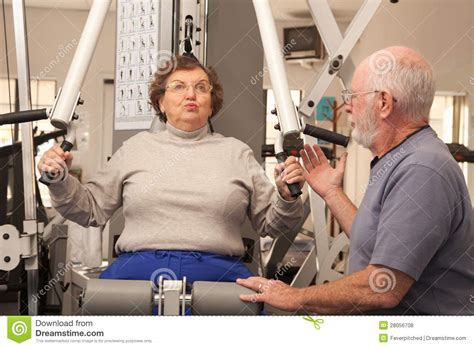 Fit Senior Adult Couple Working Out Together In The Gym Stock Photo