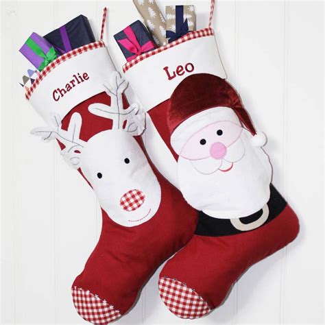 Two Christmas Stockings With Santa Claus And Reindeer On Them Hanging