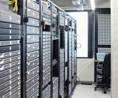 Servers in an aisle of racks in a computer server farm. - Stock Photo ...