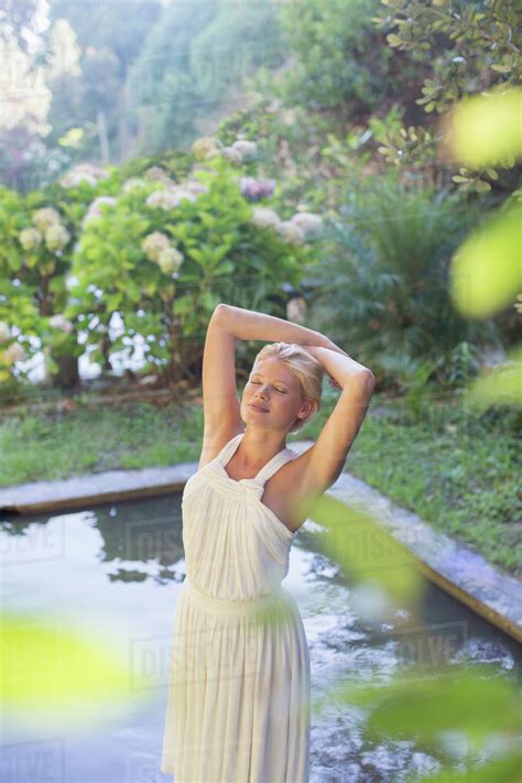 Woman Standing By Pool Outdoors Stock Photo Dissolve