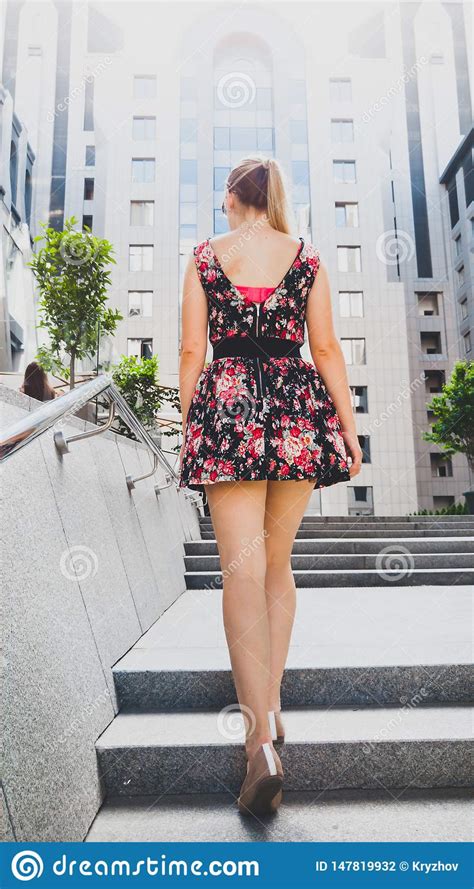 Rear View Image Of Beautiful Young Woman With Long Legs Wearing Short