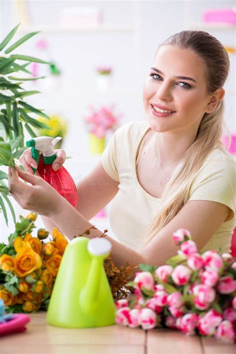 The Young Woman Watering Plants In Her Garden Stock Photo Image Of