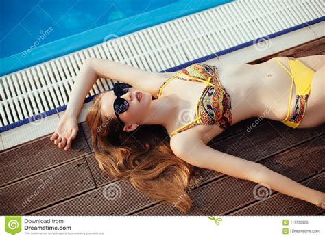 Woman In Bikini Enjoying Summer Sun And Tanning During Holidays Near Pool Top View Woman In