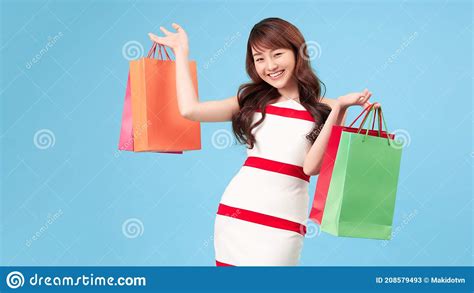 Seasonal Sales. Beautiful Shopaholic Young Girl with Lots of Shopping