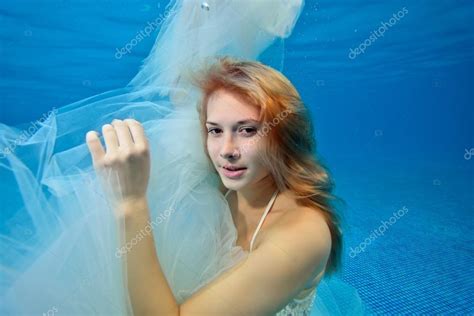 Beautiful Girl In White Wedding Dress Posing Underwater Portrait