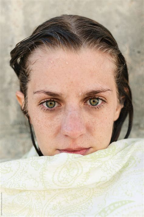 Portrait Of A Young Woman With Wet Hair Covered With A Towel Outdoors
