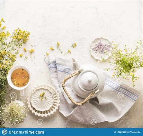 Herbal Tea Setting With Fresh Medical Herbs Teapot And Cup Of Tea