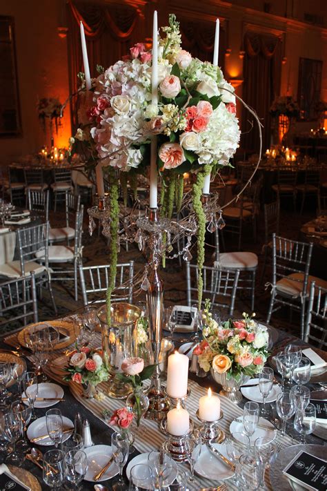 Garden flowers delivery near me. Cluster of florals on a candelabra by Avant Gardens Miami ...