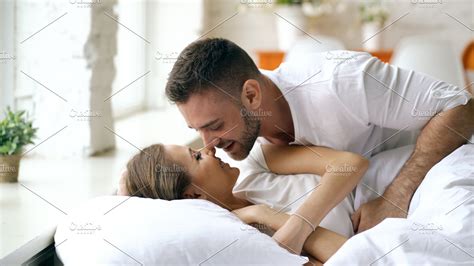 Young Beautiful And Loving Couple Wake Up At The Morning Attractive Man Kiss And Hug His Wife