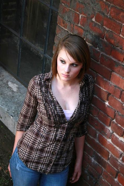 Young Woman Leaning Against Brick Wall Stock Image Image 20866491