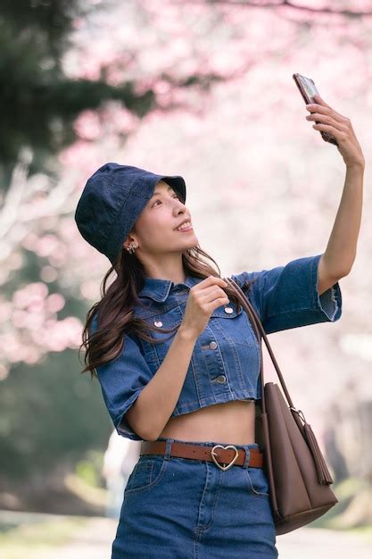 Premium Photo Woman Take Selfie With Cherry Blossoms Or Sakura Flower Blooming In The Park