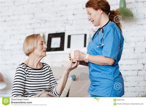 Experienced Skillful Private Doctor Treating Her Elderly Patient Stock