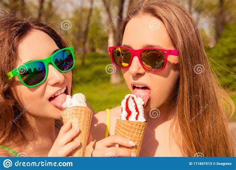Portrait Of Two Girls In Glasses Licking Ice Cream Stock Image Image