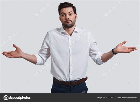Confused Young Man Gesturing Hands Stock Photo By ©gstockstudio 187722510