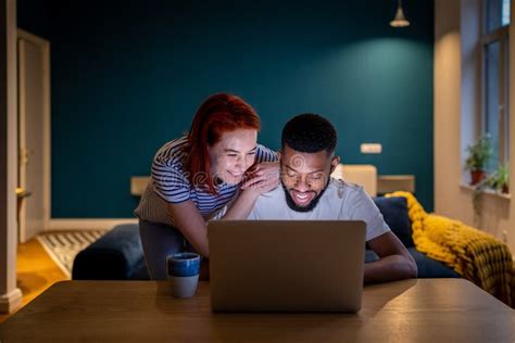 Happy Smiling Interracial Couple Man And Woman Look At Laptop Screen