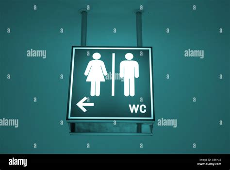Men And Women Toilet Sign With An Arrow Showing Direction Stock Photo