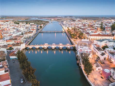Tourist guide about tavira, portugal. Tavira. Adeus, ponte militar. Olá... mono de betão?