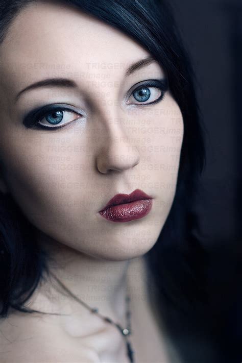 Blue eyes & pale skin makeup tutorial. Female youth twenties indoors alone. | Trigger Image