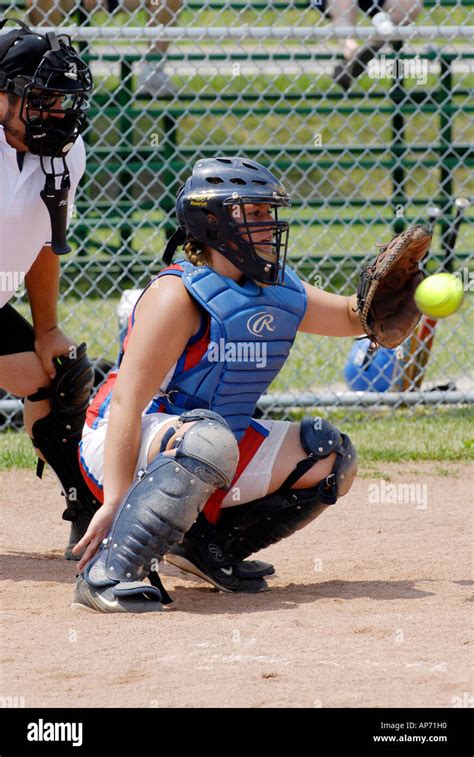 Baseball Action As Female Softball Catcher Player Catching A Ball Stock