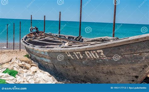 An Old Wooden Boat On The Sea Stands On The Beach Lost Editorial Stock