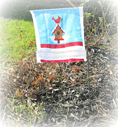 Thread rope through the pulleys and tie a knot in the rope just above the lower pulley. Homemade $1 Garden Flag - momhomeguide.com